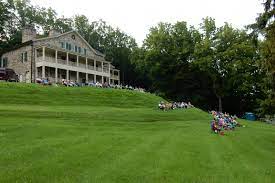 Image of Shippen Manor with visitors for concerts sitting on the terraced lawn